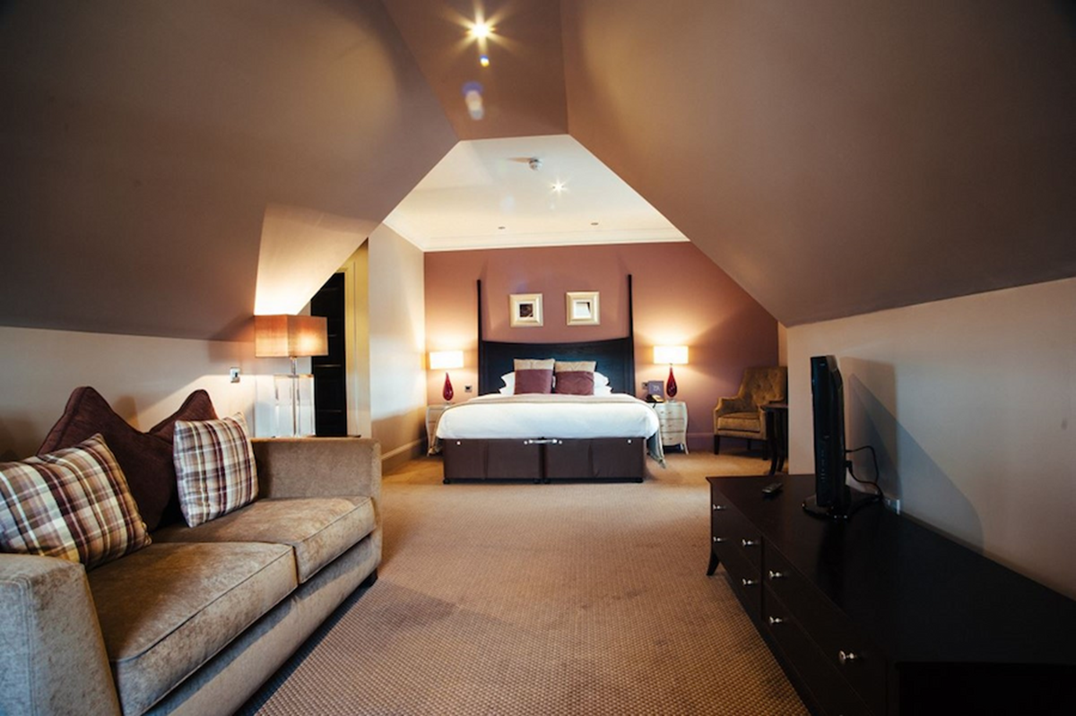 An image of a large bedroom that is available at the Dumfries Arms Hotel.